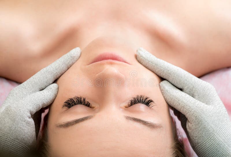 Woman getting lifting therapy massage in a beauty SPA salon