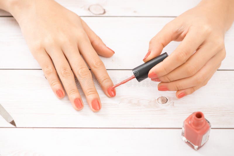 Woman getting nail manicure. Manicurist applying red nail polish. royalty free stock images Woman getting nail manicure. Manicurist applying red nail polish. royalty free stock images