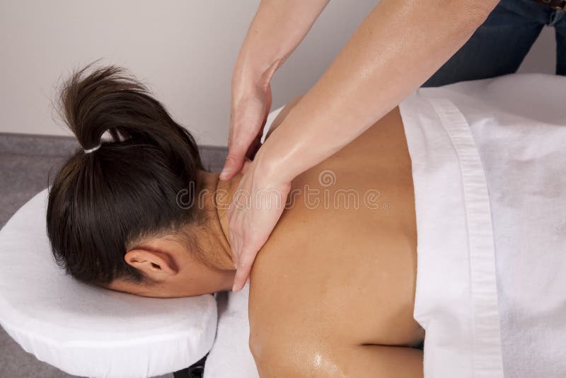 Woman getting neck massaged