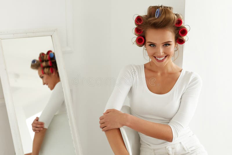 Beautiful Happy Female Model With Hair Rollers On Healthy Blonde Hair royal...