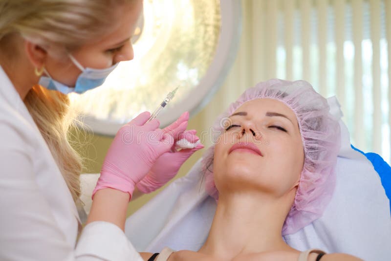 Woman getting treatment with injectable hyaluronic acid dermal filler