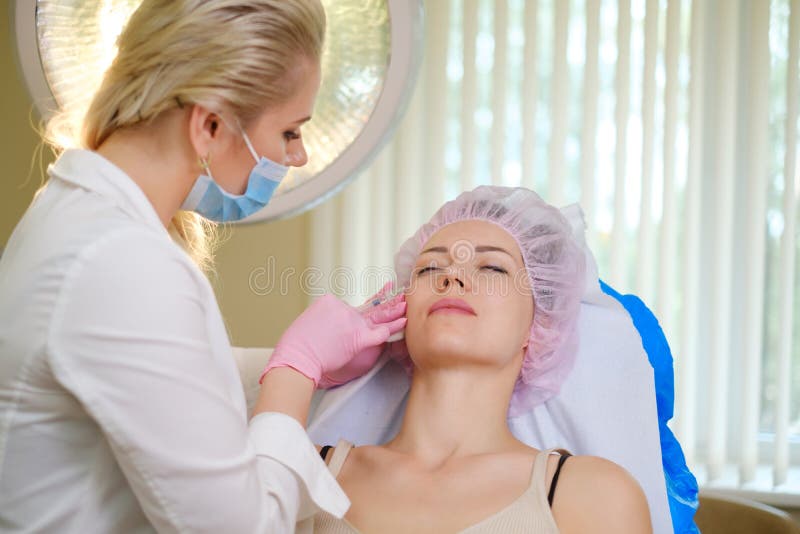 Woman getting treatment with injectable hyaluronic acid dermal filler