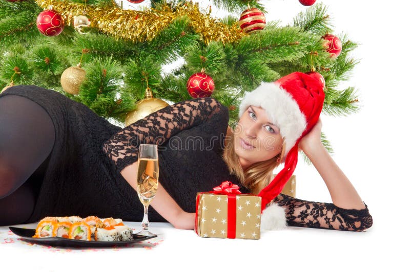 Woman with gift under christmas tree