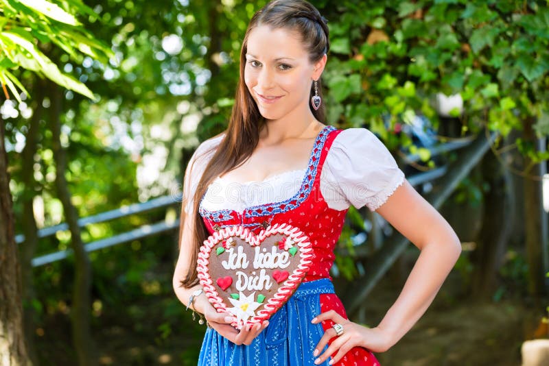 Woman with gingerbread hart in Bavaria beergarden