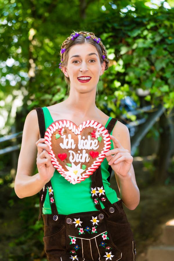 Woman with gingerbread hart in Bavaria beergarden