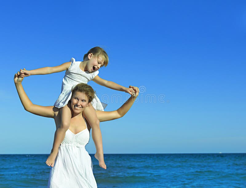 Woman and girl on the beach