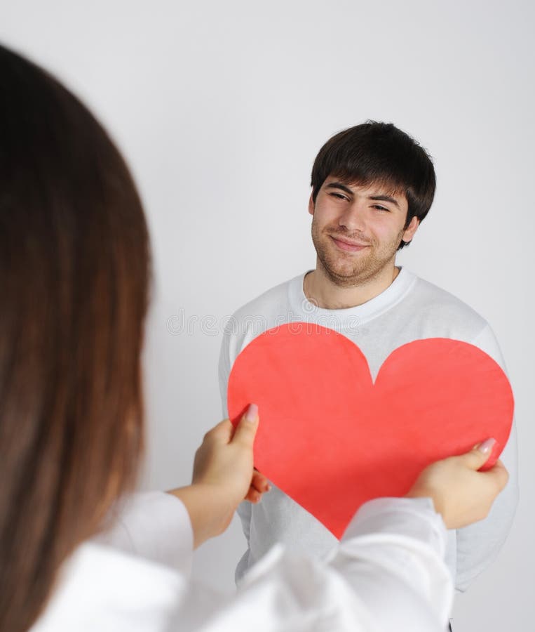 Woman giving to young man love symbol