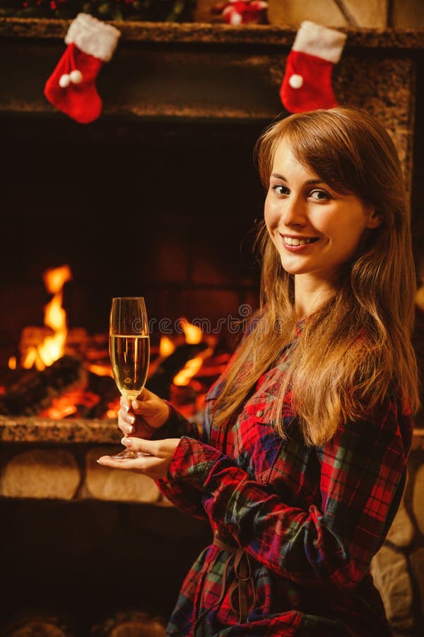 Woman with a Glass of Champagne by the Fireplace. Young Woman Si Stock ...