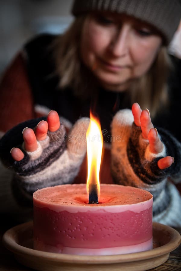 A woman with gloves warms her hands royalty free stock image