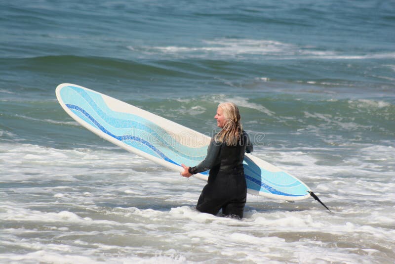 Woman going surfing royalty free stock photography