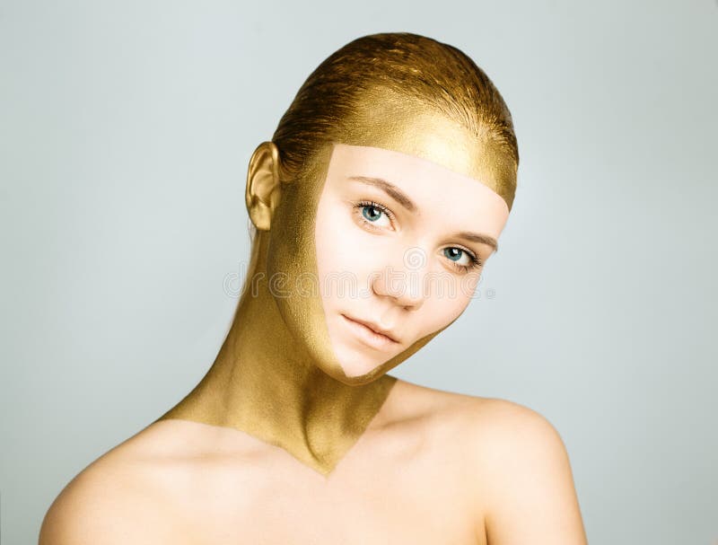 Woman with gold face make up