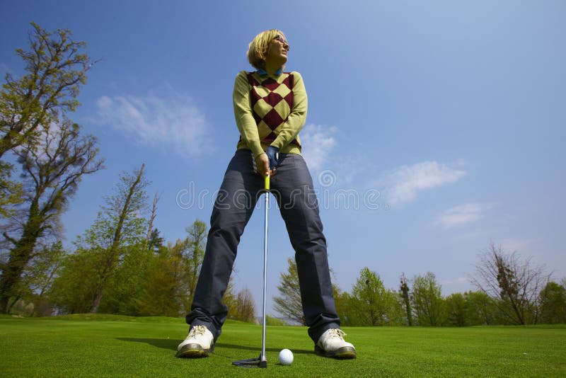 Woman on a golf course aiming