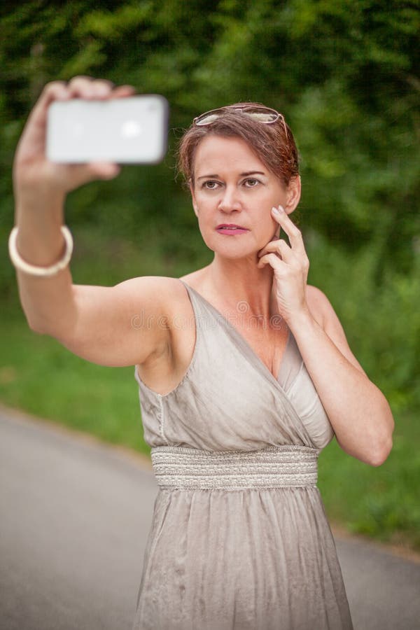 Woman In Gown Taking Self Portrait With Cell Phone Stock Image Image Of Attractive Phone