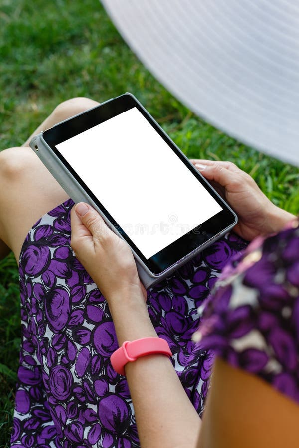 Woman on grass with tablet royalty free stock photos