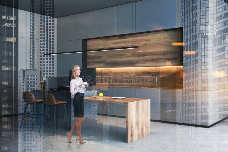 Woman in gray kitchen with bar stock photo Woman in gray kitchen with bar stock photo