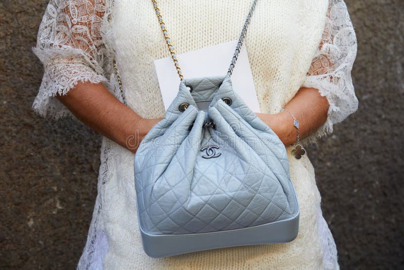 Man with Chanel Backpack before Salvatore Ferragamo Fashion Show