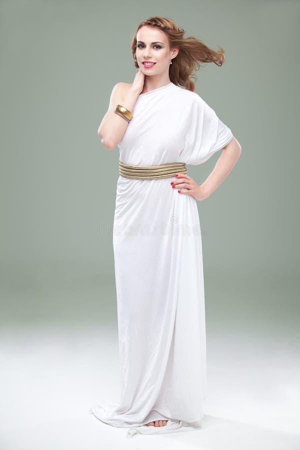 Woman in greek inspired white dress, smiling