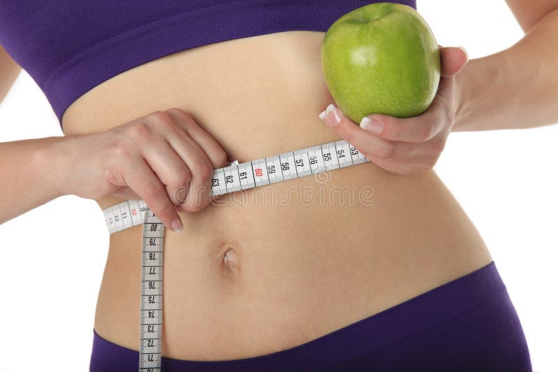 Woman with green apple and measure tape