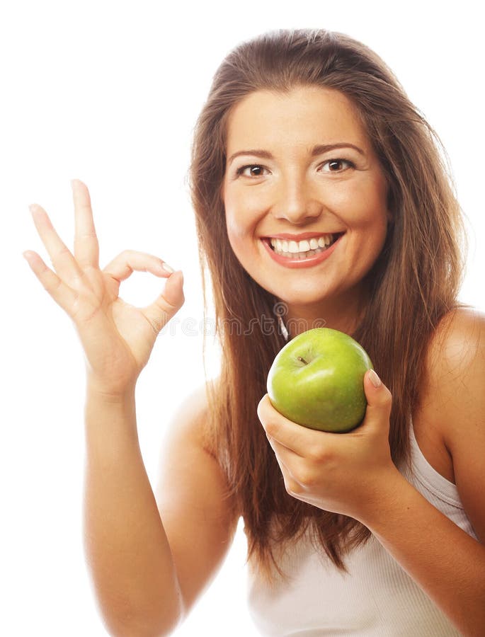 Woman with green apple and showing thumb up