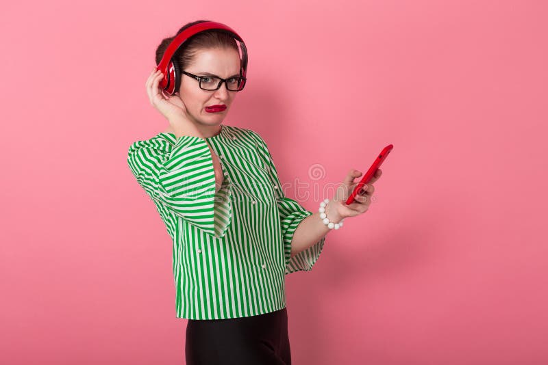 Businesswoman with phone and earphones stock photography Businesswoman with phone and earphones stock photography