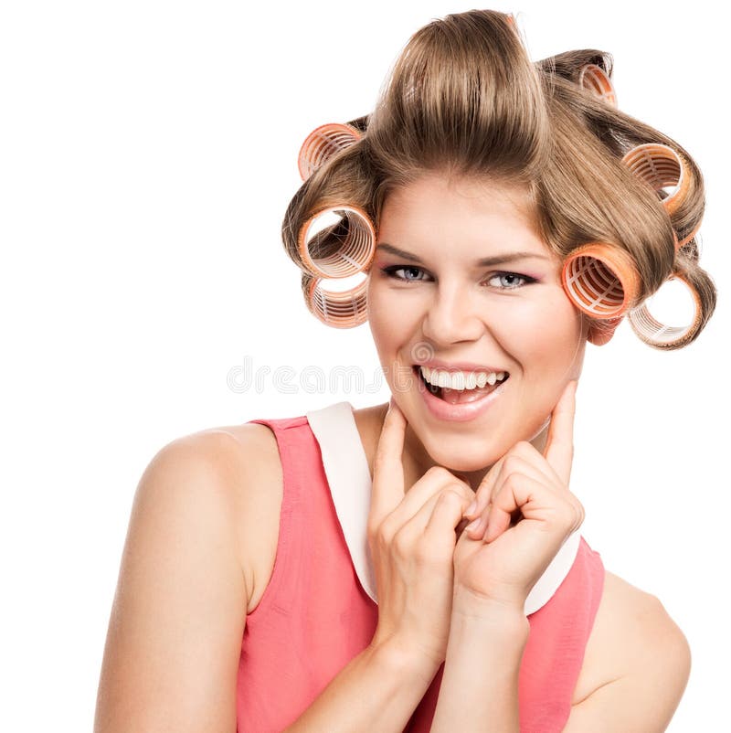 Portrait of happy blond Caucasian woman with hair curlers, isolated over wh...