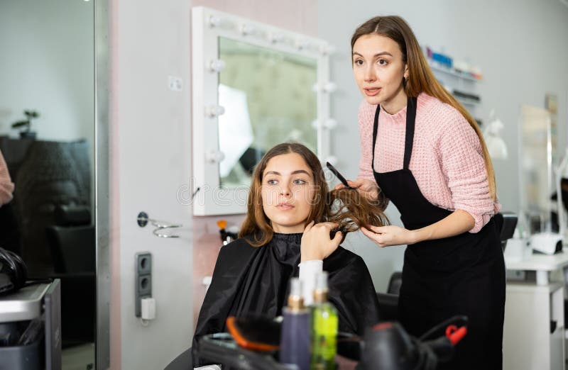 Woman Hair Stylist Discussing New Hairdo with Young Female Customer ...