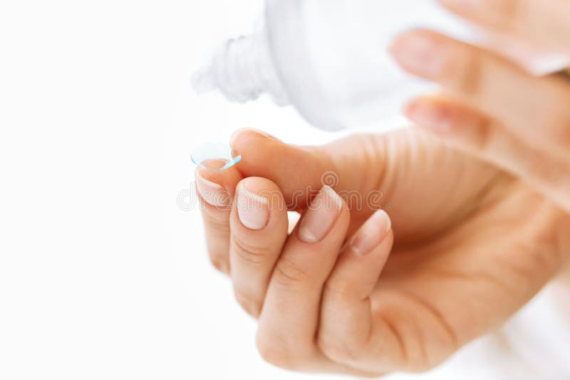 Woman Hand With Contact Eye Lens And Cleansing Solution