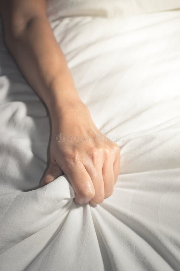 Woman hand having sex on a bed. Woman hand having sex on a bed