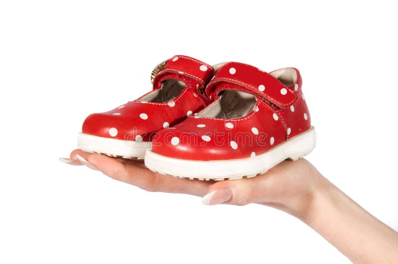 Woman hand holding baby shoes