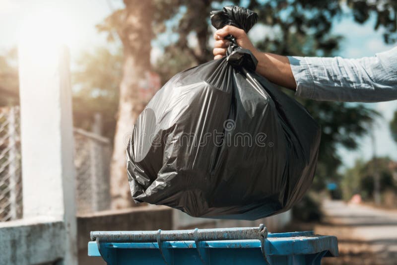 woman hand holding garbage bag put in to trash