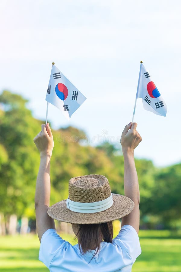 Woman Hand Holding Korea Flag On Nature Background National Foundation