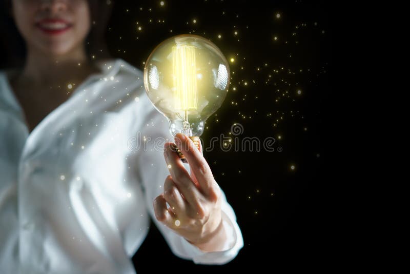 Woman hand holding light bulb. idea concept with inspiration