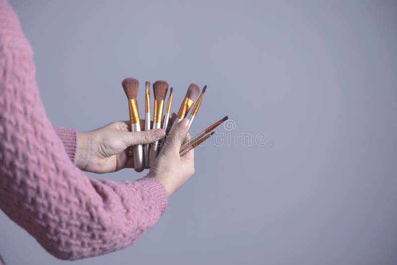 Woman hand makeup brushes stock photo. Image of brush 176657594