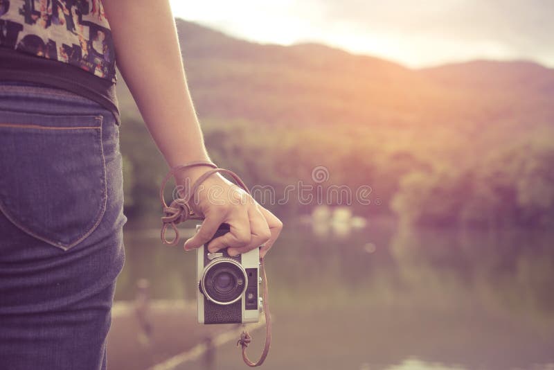 woman hand holding retro camera.