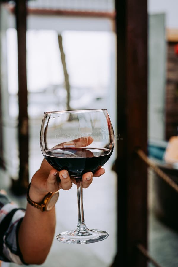 Woman Hand Holding a Wine Glass with Red Wine Stock Image - Image of