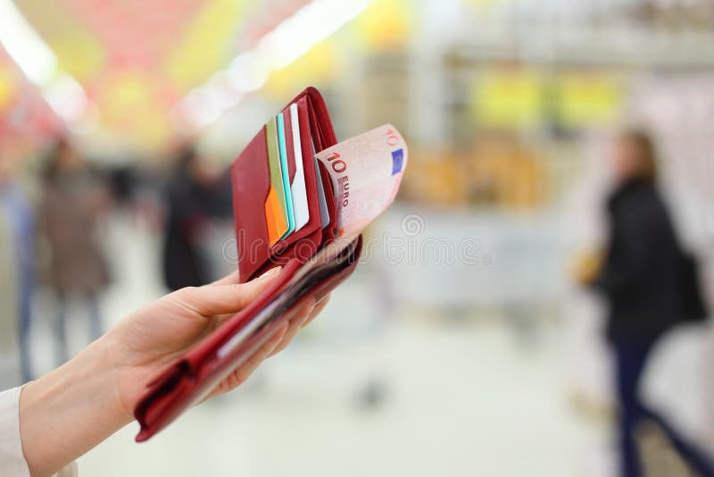 Woman hand keep purse with money and credit cards