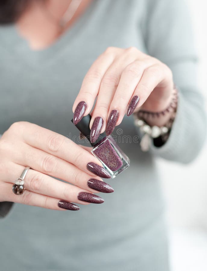 Woman Hand with Nails and a Bottle of Dark Brown Red Nail Polish Stock  Photo - Image of cosmetic, lacquer: 219527268