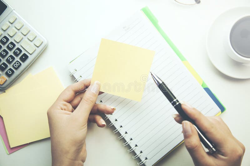 Woman hand notebook and calculator on wooden table stock images