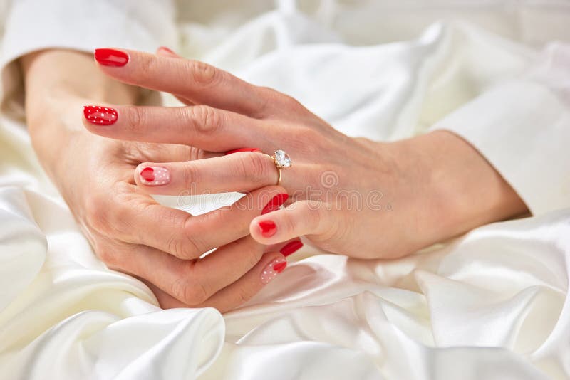 Woman hand touching her ring on finger.