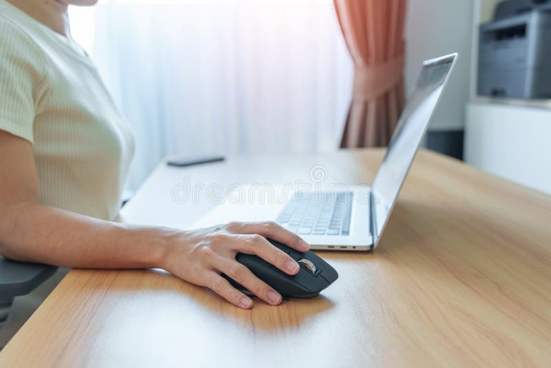 Woman Hand Using Ergonomic Vertical Mouse during Working on Adjustable