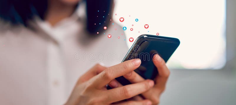 Woman hand using smartphone and show heart icon social media. Concept social network. stock images