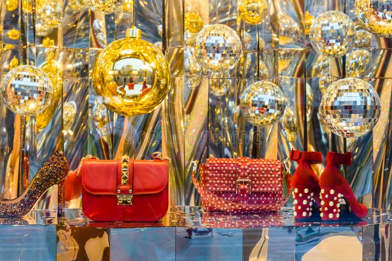 Woman handbags and different christmas decorations in a showcase