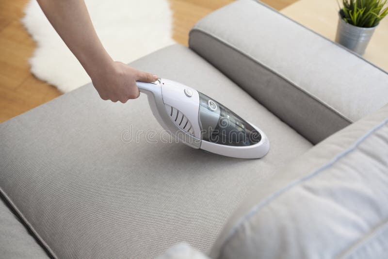 Woman with Handheld Vacuum Cleaning on Sofa Stock Photo Image of