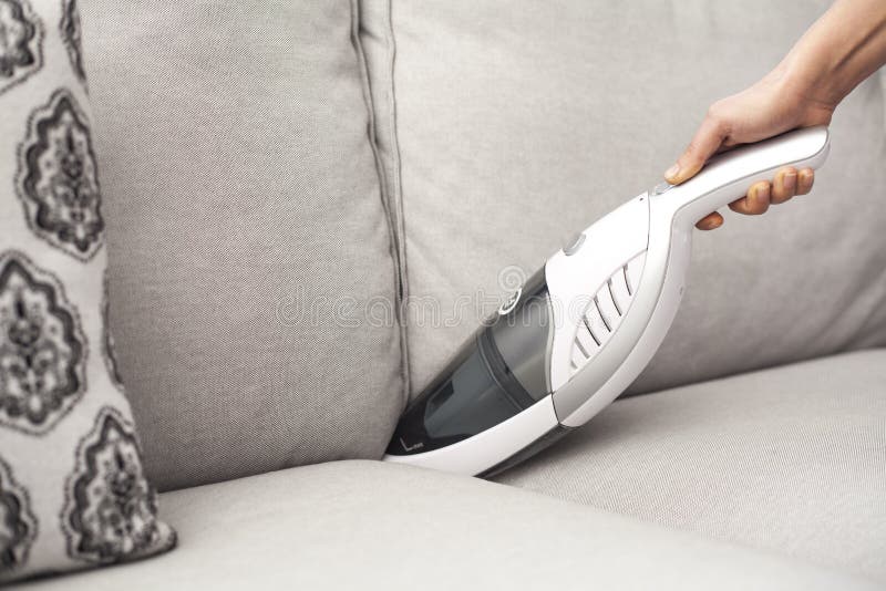 Woman with Handheld Vacuum Cleaning on Sofa Stock Photo Image of