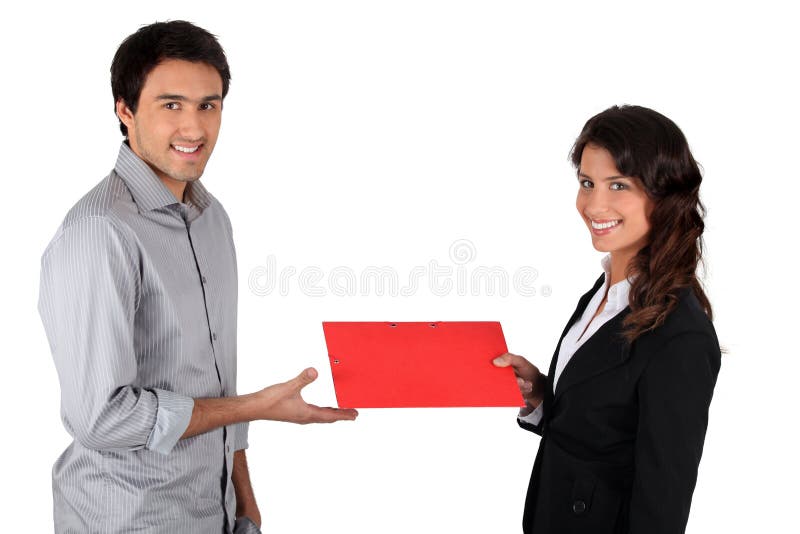 Woman handing red folder to man