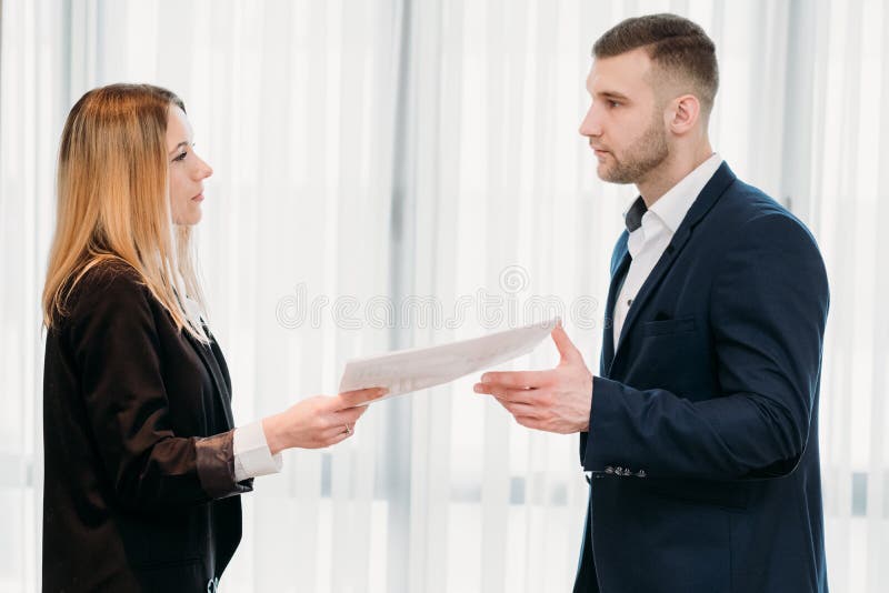 Woman handing her letter of resignation to a strict boss. business career change. job quitting. voluntary discharge. Woman handing her letter of resignation to a strict boss. business career change. job quitting. voluntary discharge