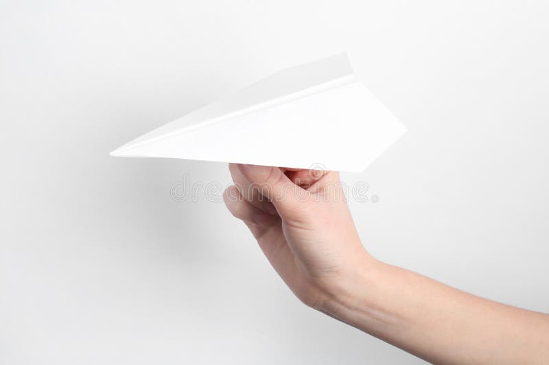 Woman with handmade paper plane on white background closeup fotografía de archivo