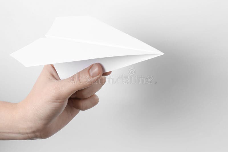 Woman with handmade paper plane on white background closeup imagenes de archivo