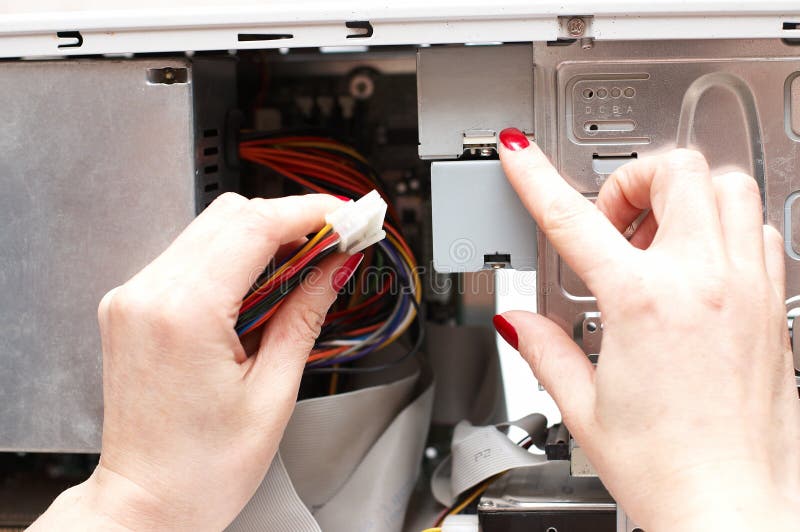 Woman hands assemble computer cable royalty free stock photography