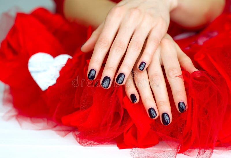 Woman hands with dark manicure